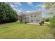 Lush green backyard with mature trees offering shade and privacy to the home at 10325 Merlin Meadows Ct, Charlotte, NC 28277