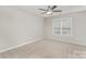 Bedroom featuring neutral walls, carpet, ceiling fan and natural light at 10325 Merlin Meadows Ct, Charlotte, NC 28277