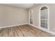 Bright bedroom with hardwood floors and arched windows providing natural light at 10325 Merlin Meadows Ct, Charlotte, NC 28277