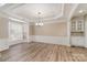 Formal dining room with hardwood floors, elegant lighting, and bay window at 10325 Merlin Meadows Ct, Charlotte, NC 28277