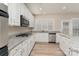Updated kitchen with stainless steel appliances and white cabinets at 10325 Merlin Meadows Ct, Charlotte, NC 28277