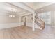 Bright living room with high ceilings and hardwood floors, with staircase at 10325 Merlin Meadows Ct, Charlotte, NC 28277