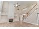 Open concept living room featuring a fireplace, staircase, and built ins at 10325 Merlin Meadows Ct, Charlotte, NC 28277