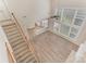 Bright living room featuring large windows, hardwood floors, and a staircase leading to the second floor at 10325 Merlin Meadows Ct, Charlotte, NC 28277