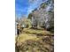 Spacious backyard featuring lush greenery, flowering trees, and a storage shed at 104 Edgewater Nw Dr, Concord, NC 28027