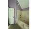 A bathroom featuring a tub with a shower and ceramic tile at 104 Edgewater Nw Dr, Concord, NC 28027