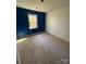 Bedroom showcasing carpeted floors, blue accent wall, neutral walls, and a window at 104 Edgewater Nw Dr, Concord, NC 28027