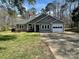 Charming single-story home featuring a gray exterior, attached garage, and well-maintained front yard at 104 Edgewater Nw Dr, Concord, NC 28027