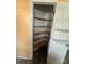 Walk-in pantry features corner shelving and a door with additional rack storage at 104 Edgewater Nw Dr, Concord, NC 28027
