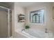 Well-lit bathroom with a soaking tub and unique stained glass window at 107 Southfork Dr, Belmont, NC 28012