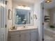 Bright bathroom with a large mirror and a separate tub room with towels and plant decor at 107 Southfork Dr, Belmont, NC 28012
