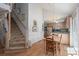 Bright dining area with hardwood floors, stairs to upper level, and access to kitchen at 107 Southfork Dr, Belmont, NC 28012