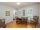 The dining room features hardwood floors, natural light, and comfortable wood chairs at 107 Southfork Dr, Belmont, NC 28012