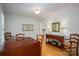 Traditional dining room featuring hardwood floors, wood furniture, and access to kitchen space at 107 Southfork Dr, Belmont, NC 28012