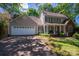 Charming home featuring a well-manicured lawn, two-car garage, and inviting front porch with green shutters at 107 Southfork Dr, Belmont, NC 28012