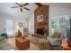 Cozy living room featuring a brick fireplace, ceiling fan, and comfortable seating arrangement at 107 Southfork Dr, Belmont, NC 28012