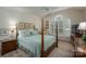 Comfortable main bedroom with canopy bed, a ceiling fan, and a large window with plantation shutters at 107 Southfork Dr, Belmont, NC 28012