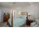 Cozy main bedroom featuring a four-poster bed, ceiling fan and neutral decor at 107 Southfork Dr, Belmont, NC 28012