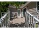 Outdoor patio with a table and chairs, sliding glass door and view of backyard at 107 Southfork Dr, Belmont, NC 28012