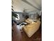 Open living room featuring a tan leather sectional sofa and ceiling fan at 110 Buffalo Nw Ave, Concord, NC 28025