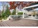 Spacious back deck featuring a dining table, overlooking the screened porch and fire pit area at 11204 Arlen Park Dr, Huntersville, NC 28078