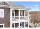 A balcony with a white railing overlooks the neighborhood street, offering a peaceful outdoor space at 11204 Arlen Park Dr, Huntersville, NC 28078