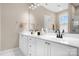 Modern bathroom with double sinks, white cabinetry, large mirror, and natural light at 11204 Arlen Park Dr, Huntersville, NC 28078