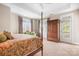 Bright bedroom with a four-poster bed, sitting area, wardrobe and access to a private balcony at 11204 Arlen Park Dr, Huntersville, NC 28078