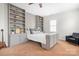 Well-lit bedroom with built-in bookshelves, a stylish bed, and a comfortable black chair at 11204 Arlen Park Dr, Huntersville, NC 28078