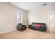 Bonus room is equipped with a large sofa, accent chair and guitar for relaxation and entertainment at 11204 Arlen Park Dr, Huntersville, NC 28078
