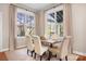 Bright dining room featuring a wood table, seating for six, and large windows overlooking the landscaped yard at 11204 Arlen Park Dr, Huntersville, NC 28078