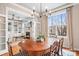 Dining room with hardwood floors, chandelier, large window, and open access to the living room at 11204 Arlen Park Dr, Huntersville, NC 28078