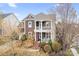 This stunning two-story home features a charming double porch, mature landscaping, and a classic design at 11204 Arlen Park Dr, Huntersville, NC 28078
