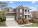 Charming two-story home with a two car garage, manicured landscaping, and inviting double-decker porch at 11204 Arlen Park Dr, Huntersville, NC 28078