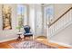 Foyer showcasing hardwood floors, a staircase, elegant rug, and a stylish sitting area at 11204 Arlen Park Dr, Huntersville, NC 28078