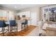 A modern kitchen with white cabinets, stainless steel appliances, granite counters, and hardwood floors at 11204 Arlen Park Dr, Huntersville, NC 28078