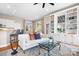 Open-concept living room with built-in bookshelves, hardwood floors, and access to the kitchen at 11204 Arlen Park Dr, Huntersville, NC 28078