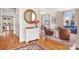 The living room features hardwood floors, neutral walls, a decorative mirror, and seating area at 11204 Arlen Park Dr, Huntersville, NC 28078