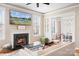 Cozy living room with a fireplace, built-in bookshelves, large screen tv, and lots of natural light at 11204 Arlen Park Dr, Huntersville, NC 28078