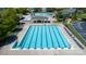 A pristine lap pool with clearly marked lanes, surrounded by ample seating and a shaded lounge area at 11204 Arlen Park Dr, Huntersville, NC 28078
