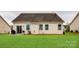 Expansive backyard with a well-manicured lawn, patio, and charming details for outdoor enjoyment at 1129 Black Walnut Rd, Clover, SC 29710