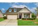 Charming brick home with a two-car garage, dormer windows, a well-manicured lawn, and rocking chairs on the front porch at 1129 Black Walnut Rd, Clover, SC 29710