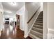 Inviting foyer with hardwood floors, staircase, and entry to the living spaces at 1129 Black Walnut Rd, Clover, SC 29710