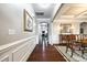 Inviting hallway with hardwood floors, elegant wainscoting, and arched doorway leading to the dining room and living area at 1129 Black Walnut Rd, Clover, SC 29710