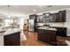 Well-equipped kitchen with dark wood cabinetry, a stainless steel refrigerator, and granite counters at 1129 Black Walnut Rd, Clover, SC 29710