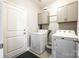 Functional laundry room with washer, dryer, cabinets, and a convenient folding area at 1129 Black Walnut Rd, Clover, SC 29710