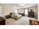 Bright main bedroom features a comfortable bed, dressers, and a window with natural light at 1129 Black Walnut Rd, Clover, SC 29710