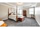 Serene main bedroom featuring a four-poster bed, ample natural light, and calming neutral tones at 1129 Black Walnut Rd, Clover, SC 29710