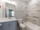 Bathroom features a single sink vanity, a large mirror and tiled shower-tub combo at 11939 Fiddlers Roof Ln, Charlotte, NC 28277