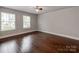 Light-filled bedroom with hardwood floors and natural light from the windows at 11939 Fiddlers Roof Ln, Charlotte, NC 28277